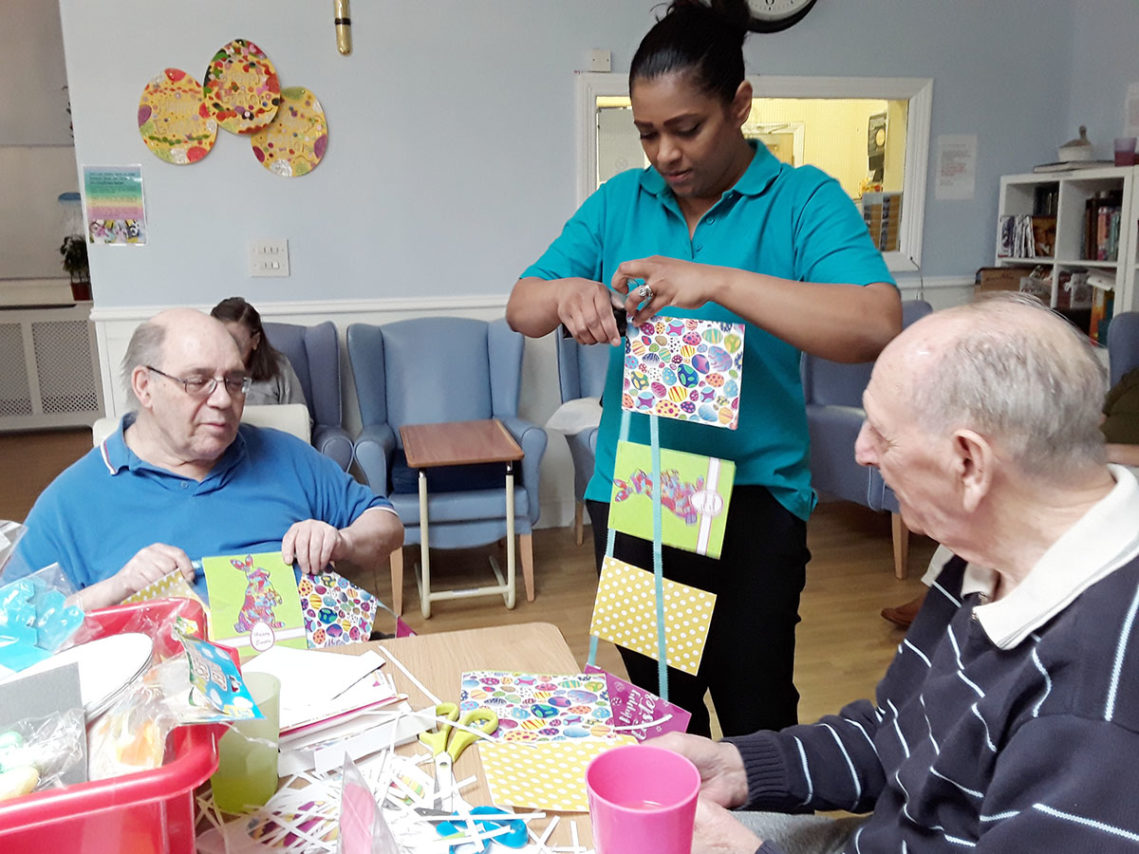 Residents and staff at Lukestone Care Home making Easter bunting together