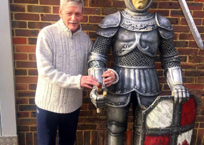 A resident from Lukestone Care Home interacting with a knight display at Hop Farm