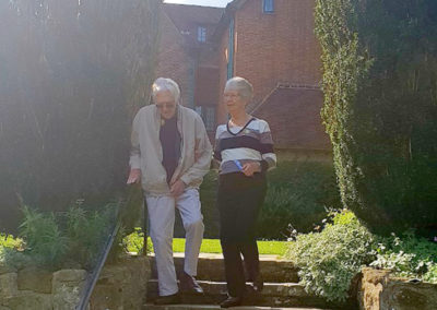 Lukestone resident and family member descending some garden steps at Chartwell House
