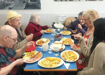 Lukestone residents eating fish and chips in a cafe