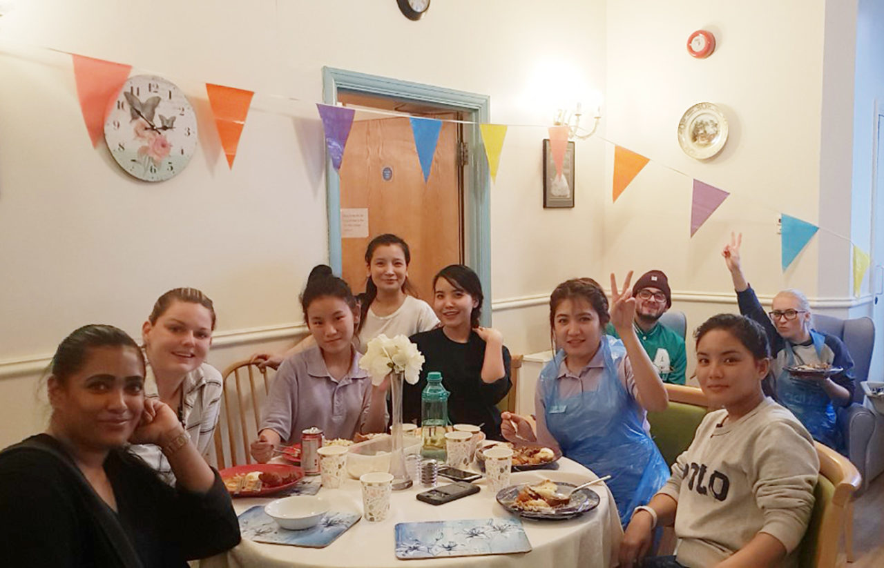 Staff at Lukestone Care Home enjoying an international lunch of dishes from around the globe