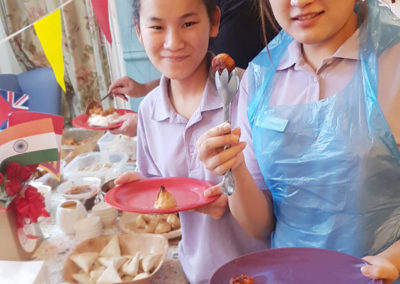 Two staff members at the lunch table trying out the different dishes on offer