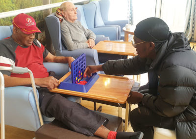 NCS member and resident playing Connect Four
