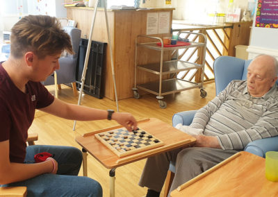 NCS member and resident playing draughts
