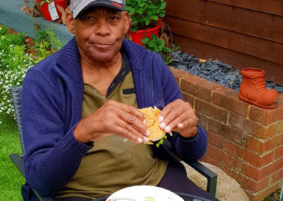 A resident enjoying a burger at the Lukestone Care Home end of summer BBQ