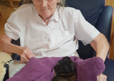 Lukestone Care Home resident with a Wild Science Guinea pig on her lap