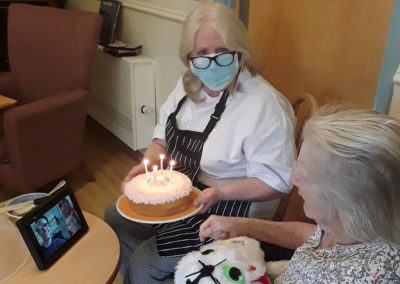 Lady resident receiving her birthday cake at Lukestone Care Home