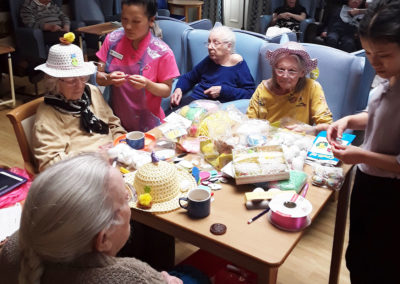 Lukestone Care Home residents making Easter bonnets 2020 with colourful decorations