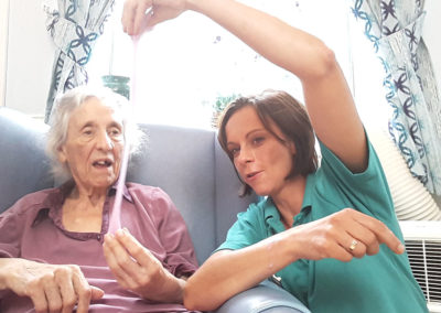 Lukestone Care Home resident stretching some slime with a staff member