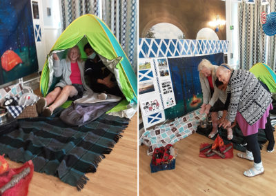 Lukestone Care Home residents having fun with a camp and fireside set up in their lounge