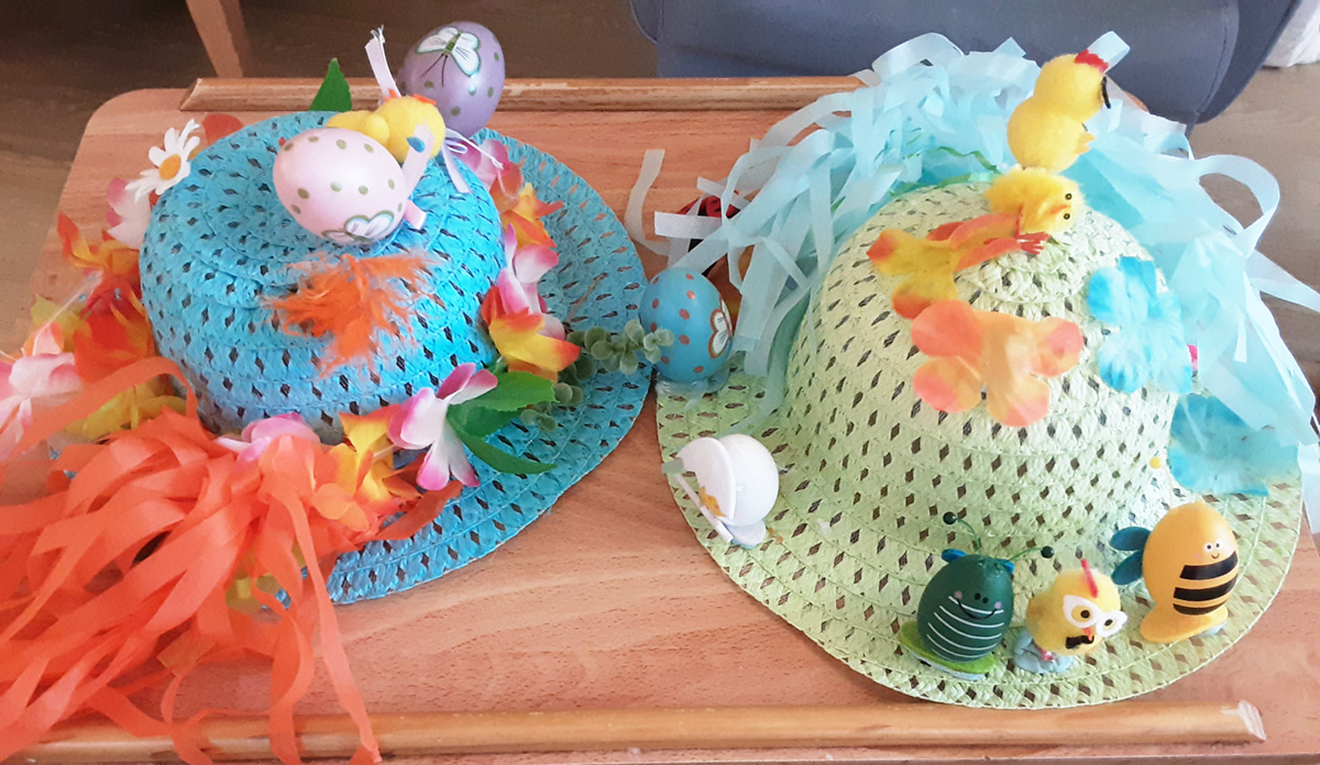 Two decorated Easter bonnets at Lukestone Care Home